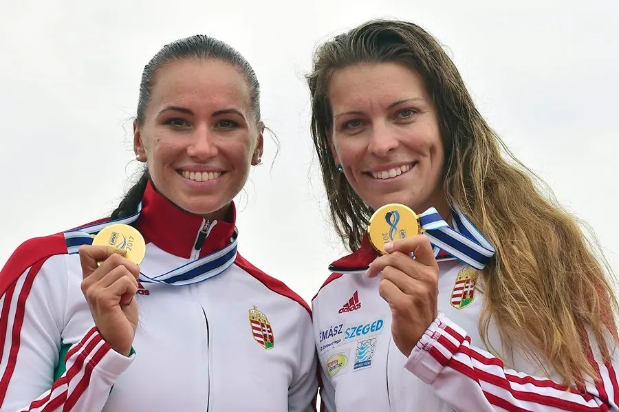 Erika Medveczky on the podium with a gold medal and teammate
