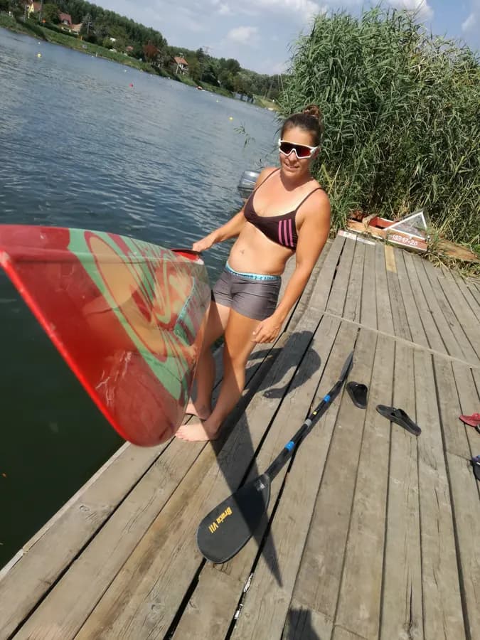 Erika Medveczky in racing kit with a gold medal