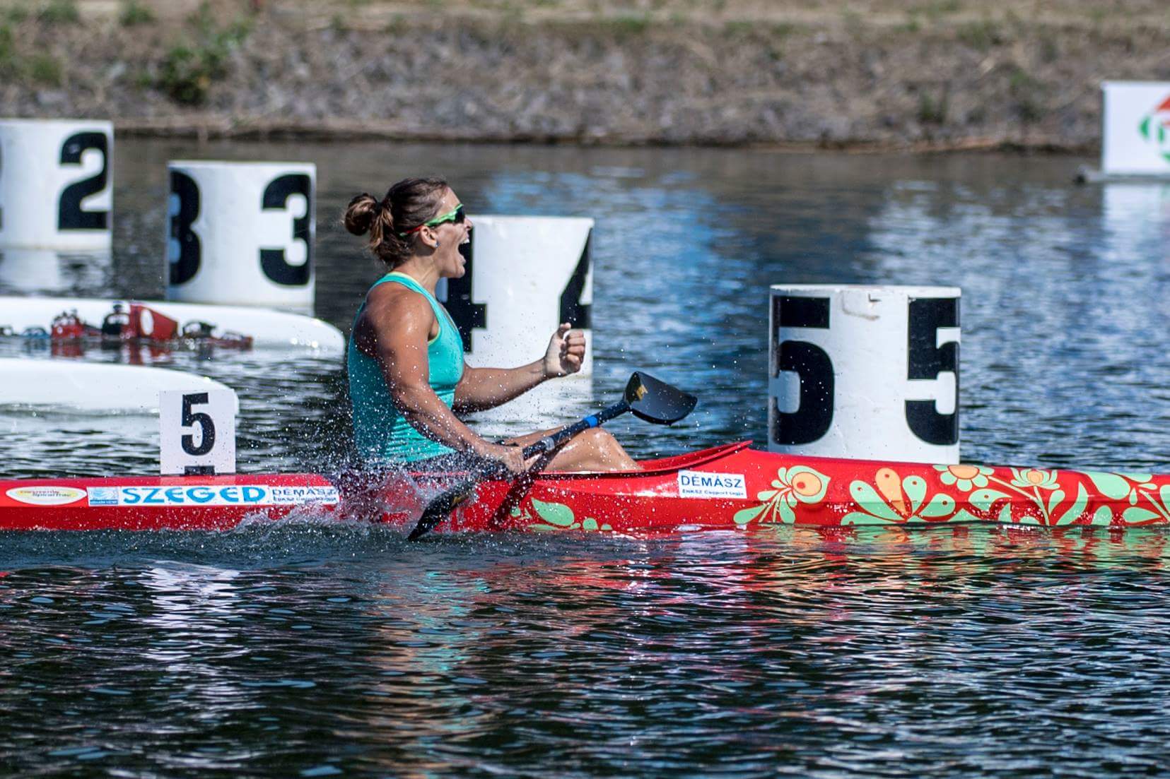 Erika Medveczky paddling past the lane markers on a race course