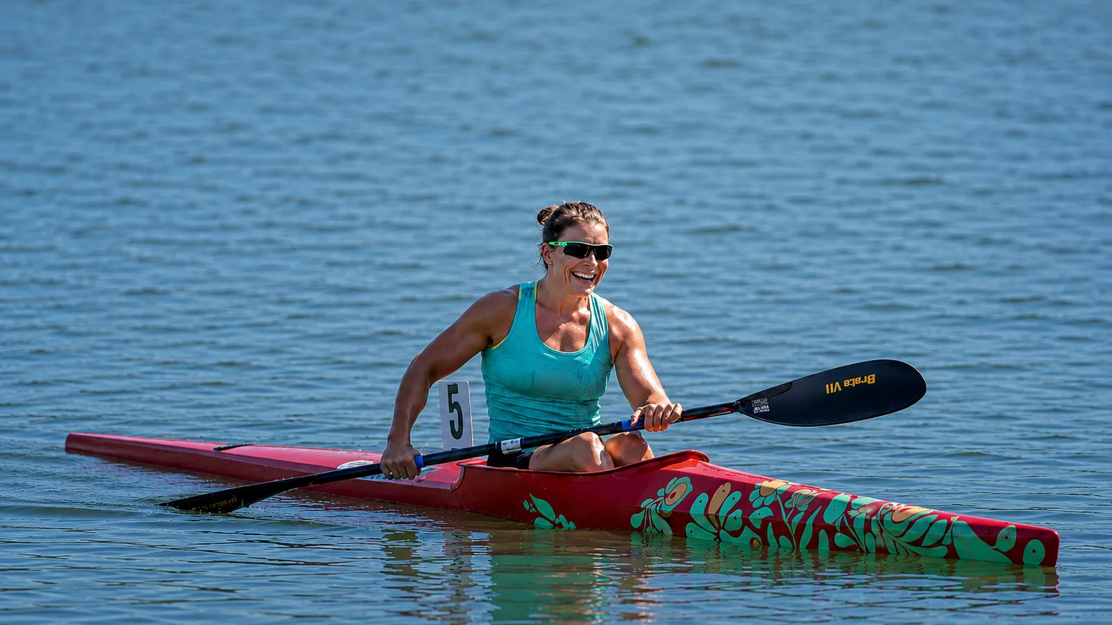 Erika Medveczky paddling her red racing kayak